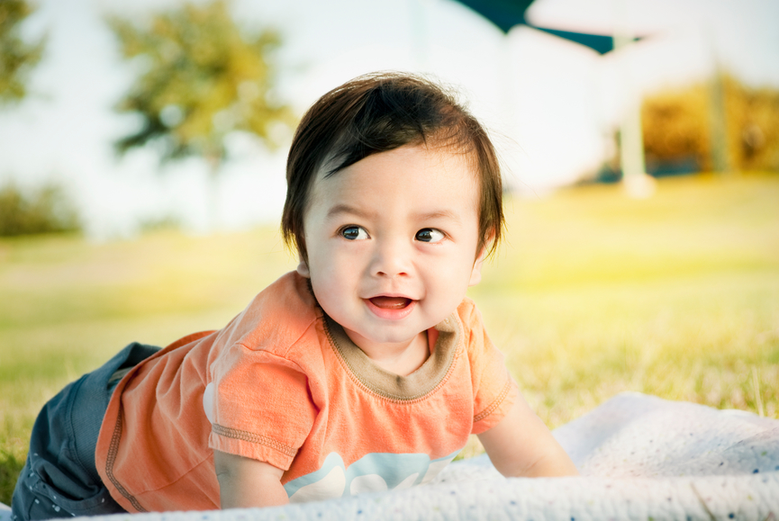 A happy 6-month old mixed-race boy (Japanese-Filipino-Caucasian), smiling at a park.